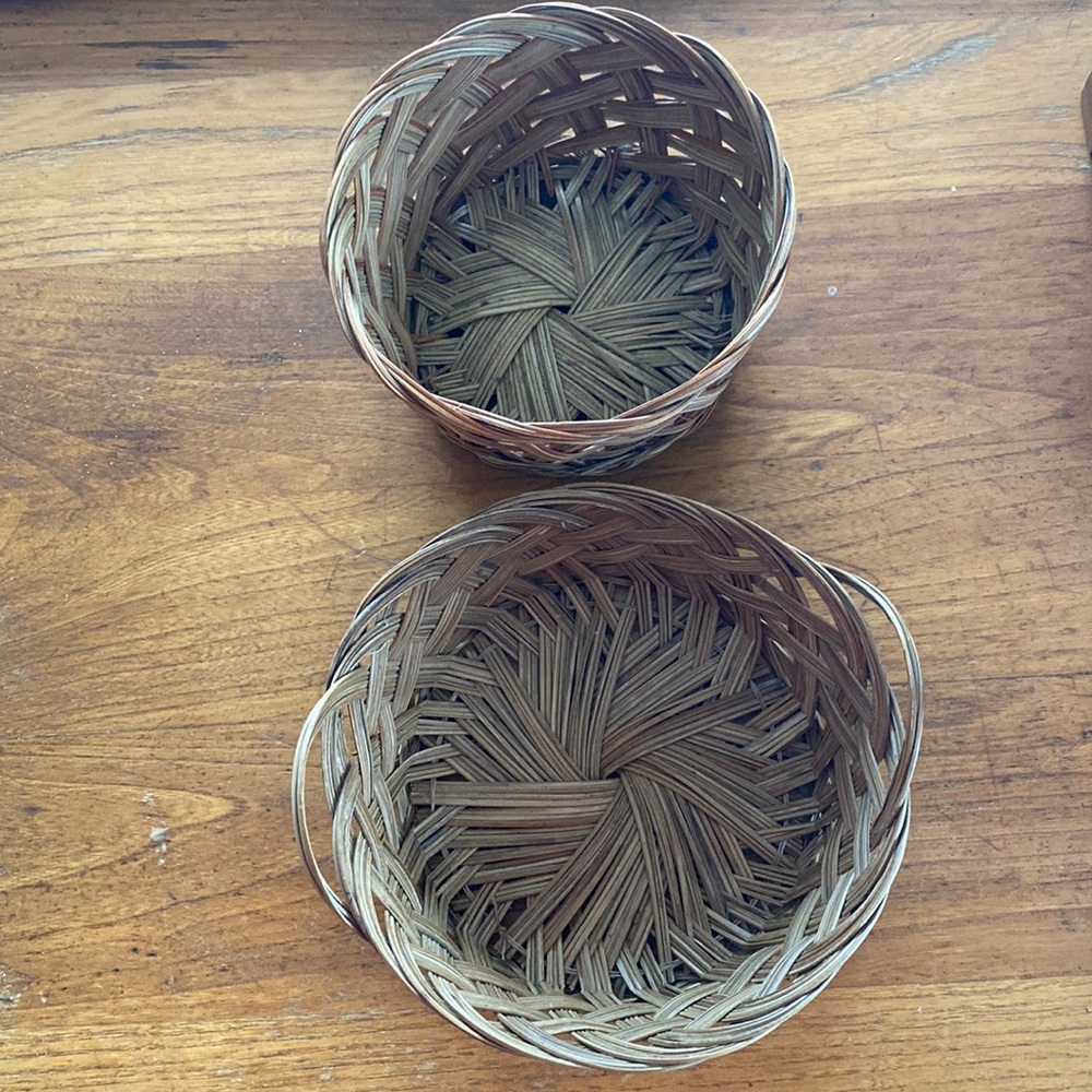 Vintage set of 2 round rattan wicker woven baskets with braided accents